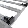 Silver car roof rack crossbars with black mounting clamps viewed from an angle on a white background, showing the end brackets and fasteners.