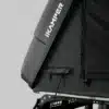 Close-up of a grey iKamper rooftop tent shell with a small black storage pocket and metal mounting frame.